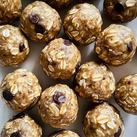 Close shot of oat balls with chocolate chips on a plate.
